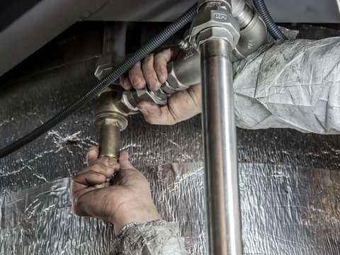 Plumber fixing a pipe